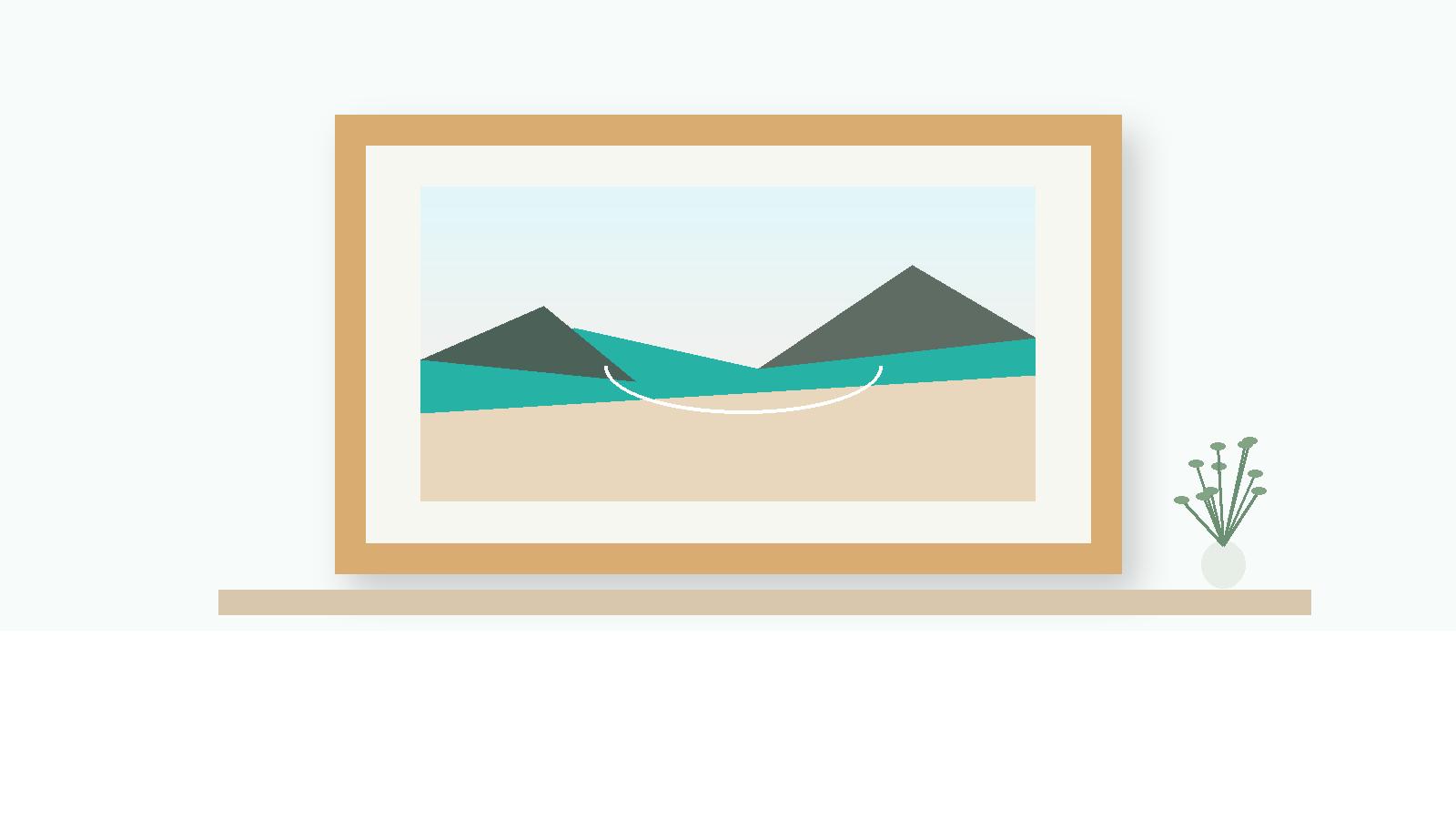 Framed coastal photograph on a shelf